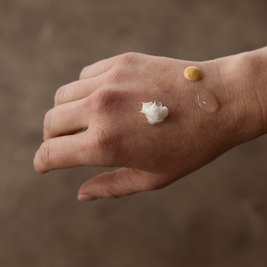 skin care products on back of hand