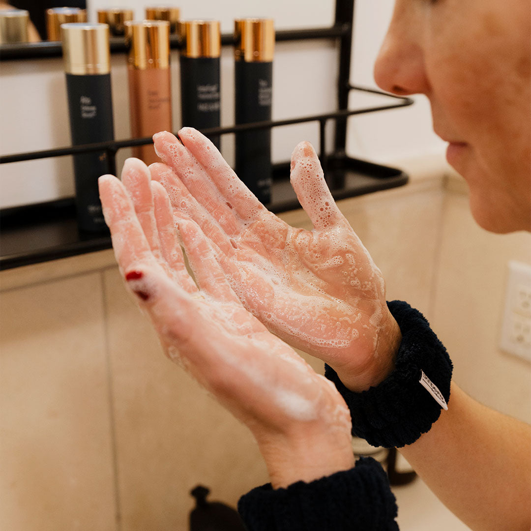 woman washing her face