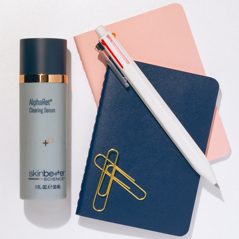skinbetter Alpharet Clearing Serum with notebook and pen